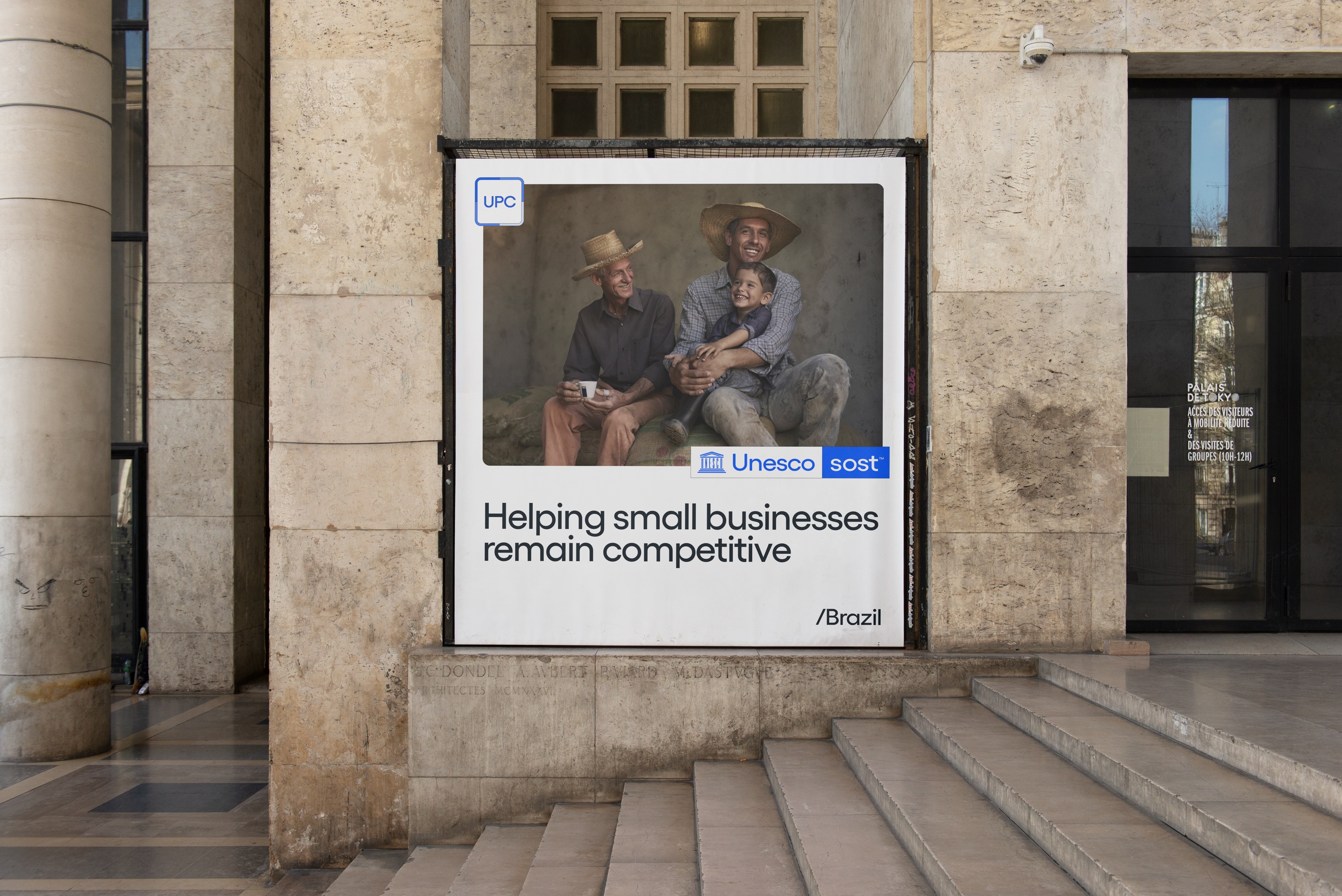 UNESCO-sost billboard featuring three generations of a family and the message Helping small businesses remain competitive